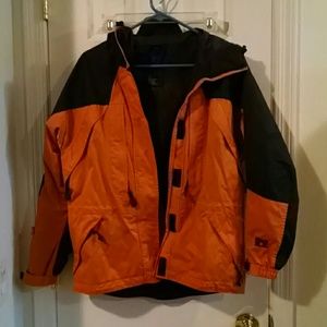 Orange and black ski/snow jacket.